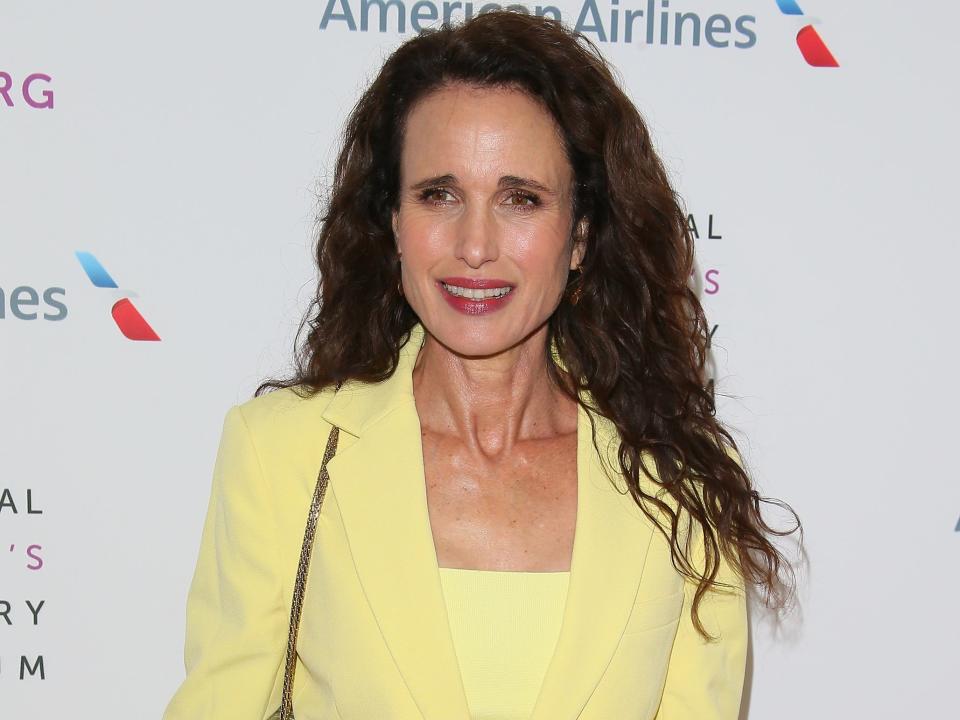 Andie MacDowell in a yellow suit