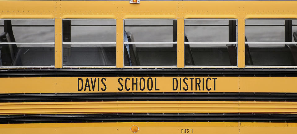 A Davis School District bus sits at the Bus Farm in Farmington, Utah, in this undated photo. A Black woman hired by the northern Utah school district to investigate racial harassment complaints a year after a 10-year-old Black student died by suicide says that she, too, experienced discrimination from district officials. Joscelin Thomas, a former coordinator in the Davis School District's equal opportunity office, alleges in a federal lawsuit that district administrators treated her “as if she were stupid," accused her of having a substandard work ethic and denied her training and mentorship opportunities that were offered to her white colleagues. (Matt Gade/The Deseret News via AP, file)