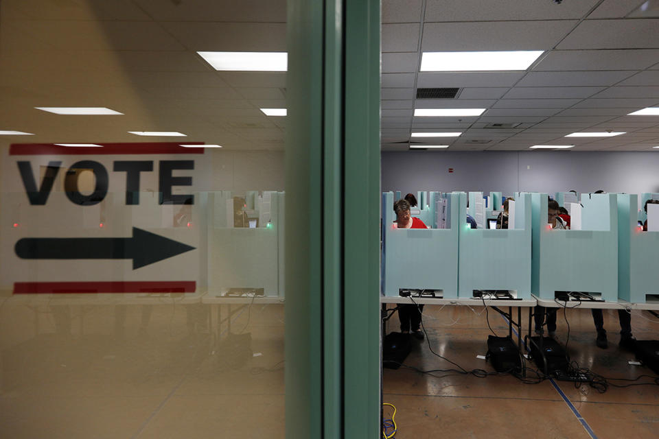 FILE - In this Nov. 6, 2018, file photo, people vote at a polling place in Las Vegas. State election officials in at least two dozen states, including Nevada, have seen suspicious cyber activity in the first half of January 2020, although it’s unclear who was behind the efforts and no major problems were reported. (AP Photo/John Locher, File)