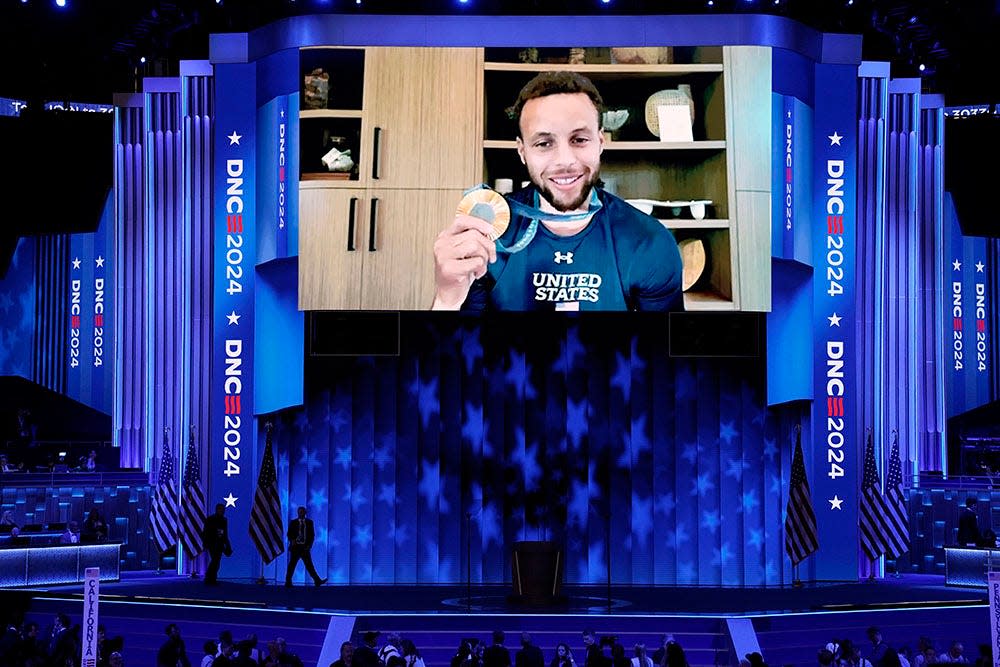 A video recording of Stephen Curry plays during the final day of the Democratic National Convention at the United Center.