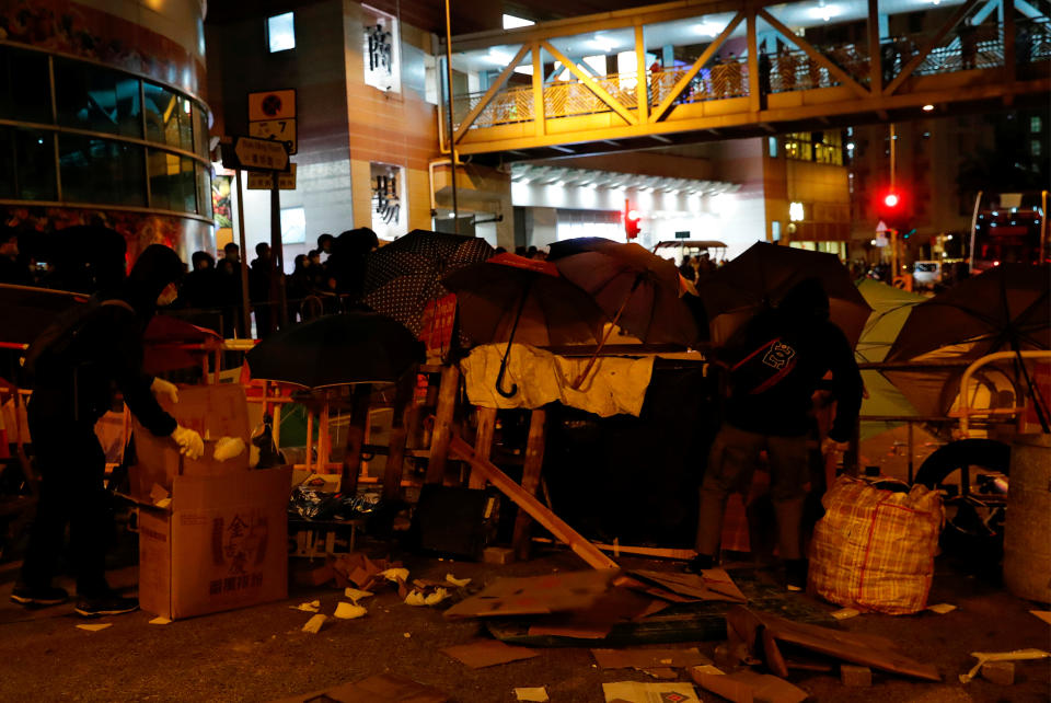 Anti-government protesters set up a barrier to block the road outside of a newly built residential building in Hong Kong that authorities planned to use as a quarantine facility, as public fears about the coronavirus outbreak intensify, in Hong Kong, China January 26, 2020. REUTERS/Tyrone Siu