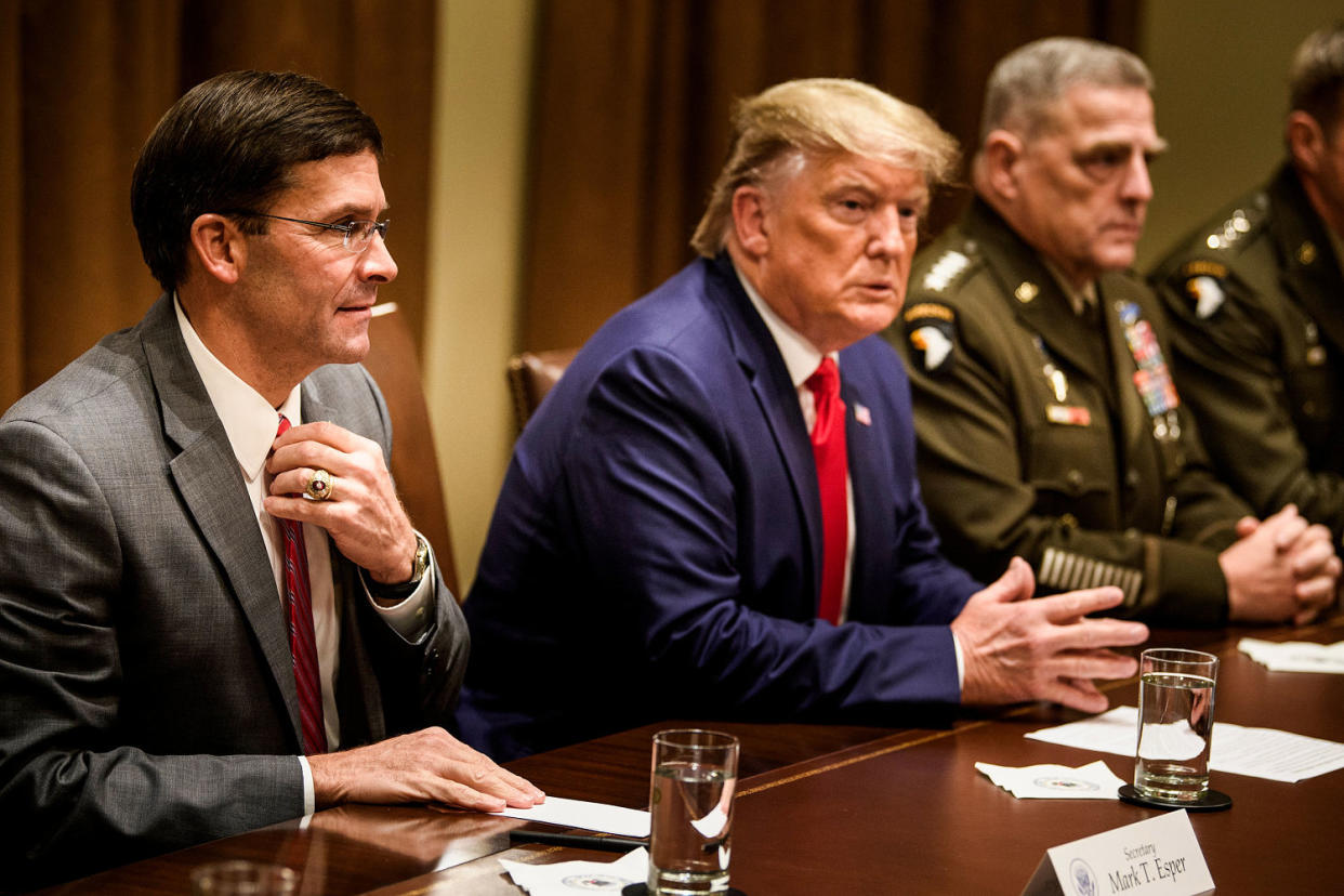 Secretary of Defense Mark Esper, left, President Donald Trump, and Chairman of the Joint Chiefs of Staff Army Gen. Mark A. Milley, right, wait for a meeting with senior military leaders in the Cabinet Room of the White House on Oct. 7, 2019. (Brendan Smialowski / AFP via Getty Images file)