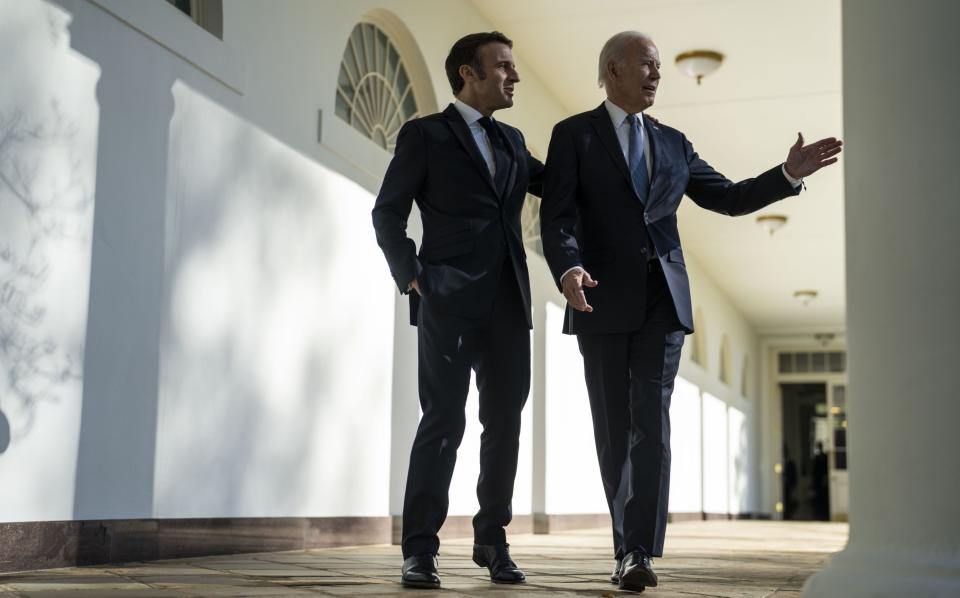 Joe Biden and Emmanuel Macron walk down the Colonnade to the Oval Office at the White House - Getty Images North America