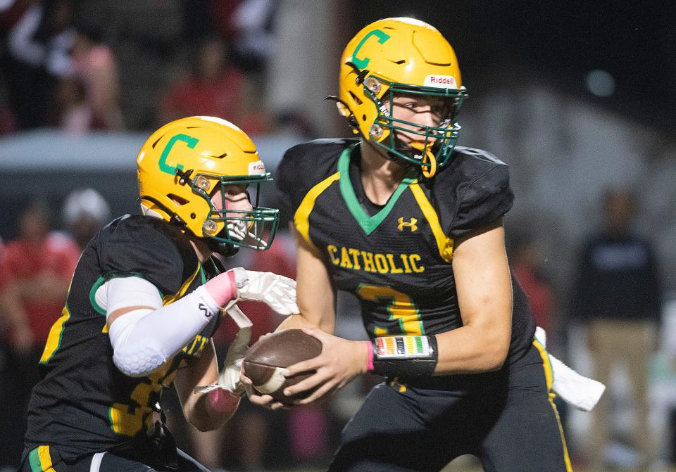 Catholic quarterback Ryan Huff (No. 3) fakes the handoff on a keeper during Friday night's game against West Florida High School.