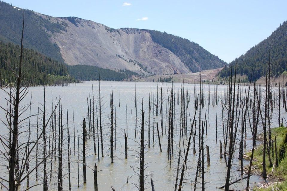 Quake Lake with submerged trees and gash of huge mountain slide that dammed the lake.