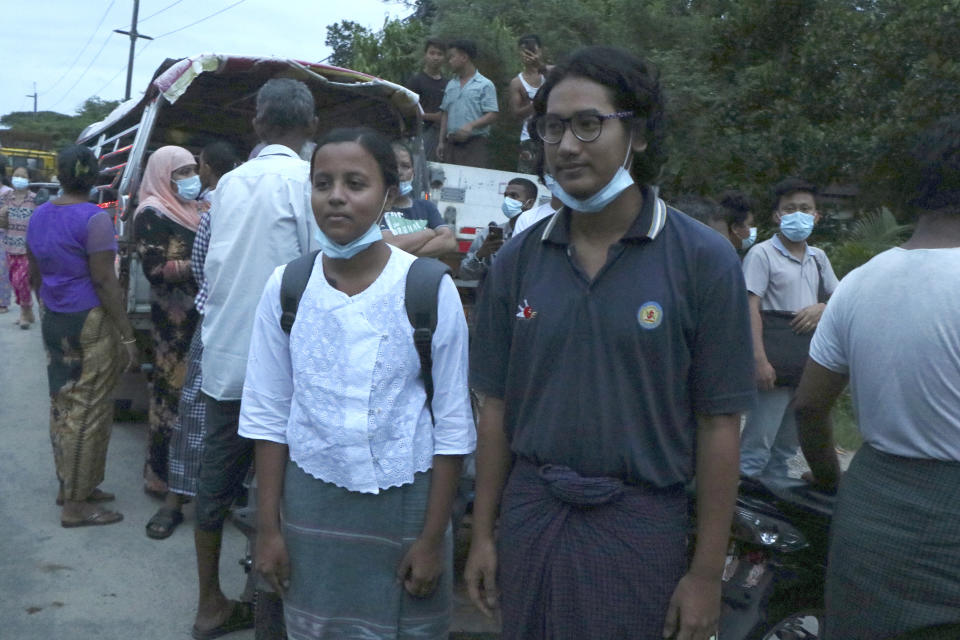 Journalists Kay Son Nway, left, and Ye Myo Khant, right, stand together after their release from Insein Prison in Yangon, Myanmar, Wednesday, June 30, 2021. Myanmar's government began releasing about 2,300 prisoners on Wednesday, including activists who were detained for protesting against the military's seizure of power in February and journalists who reported on the protests, officials said. (AP Photo)