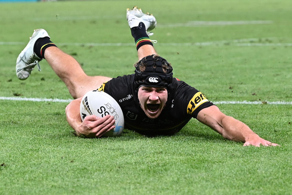 Matt Burton (pictured) scores a try during the 2021 NRL Grand Final. 