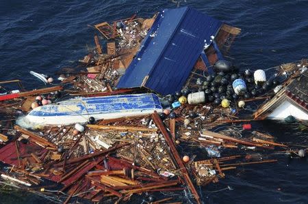 Debris is pictured floating in the Pacific Ocean, in this photograph taken on March 13, 2011 and released on March 14. REUTERS/Alexander Todd/U.S.Navy/Handout