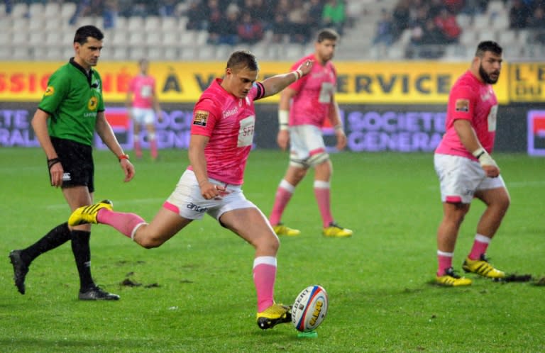 Stade Francais Paris' French flyhalf Jules Plisson (C) hits a penalty kick during the French Top 14 rugby union match between Grenoble and Stade-Français on November 29, 2015 at the Alpes stadium in Grenoble, Southeastern France