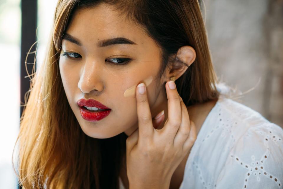 is-foundation-with-spf-enough: woman applying foundation