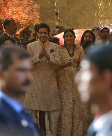 Akash Ambani, son of the Chairman of Reliance Industries Mukesh Ambani, and his fiancee Shloka Mehta greet guests at the wedding ceremony of Akash's sister Isha Ambani, in Mumbai, India, December 12, 2018. REUTERS/Francis Mascarenhas