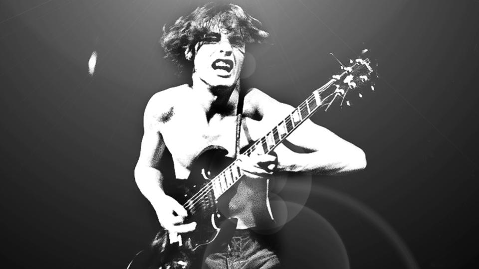 Angus Young performing live onstage on first UK tour.