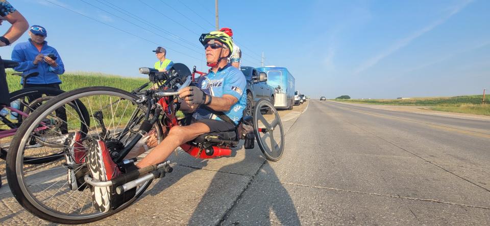 Vern Williey waits at the intersection of U.S. HWY 71 and 630th Street outside Storm Lake on the second day of the 50th anniversary RAGBRAI route inspection ride Monday.