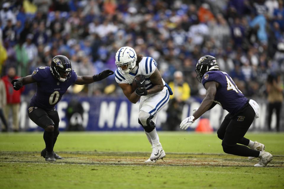 Indianapolis Colts' Drew Ogletree (85) runs against Baltimore Ravens' Roquan Smith (0) and Jeremiah Moon during the second half of an NFL football game, Sunday, Sept. 24, 2023, in Baltimore. (AP Photo/Nick Wass)