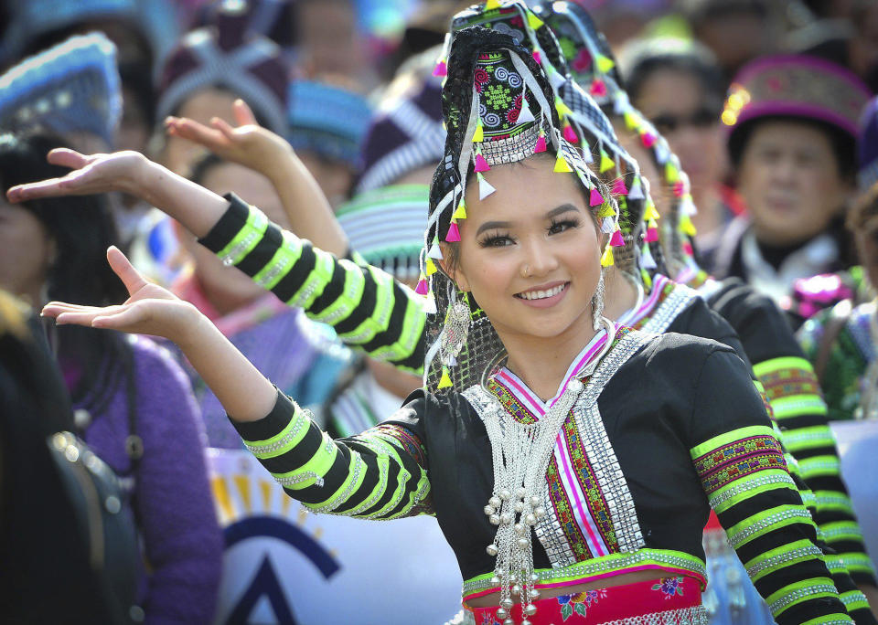 Kaitlyn Vang, 14, performs with her dance group during the parade kicking off the first day of the Hmong New Year celebration at the Fresno Fairgrounds, Thursday Dec. 26, 2019. (John Walker/The Fresno Bee via AP)