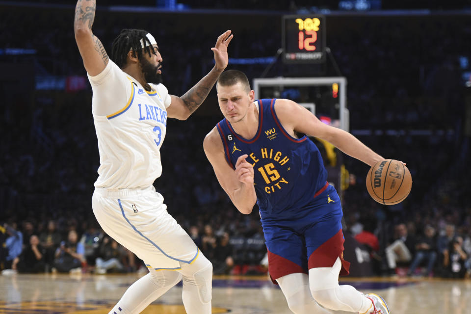 Denver Nuggets center Nikola Jokic (15) drives in opposition to Los Angeles Lakers ahead Anthony Davis (3) all over an NBA basketball game Sunday, Oct. 30, 2022, in Los Angeles. The Lakers obtained 121-110. (AP Picture/Michael Owen Baker)