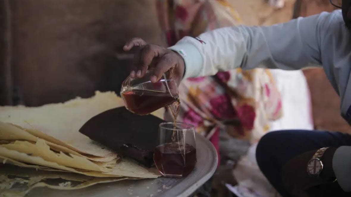 A man in Khartoum, Sudan pours a glass of helo murr, a Ramadan drink made with dried corn and spices which is then dipped in water, on Wednesday ahead of the Muslim holy fasting month of Ramadan. (Photo: Marwan Al/AP)