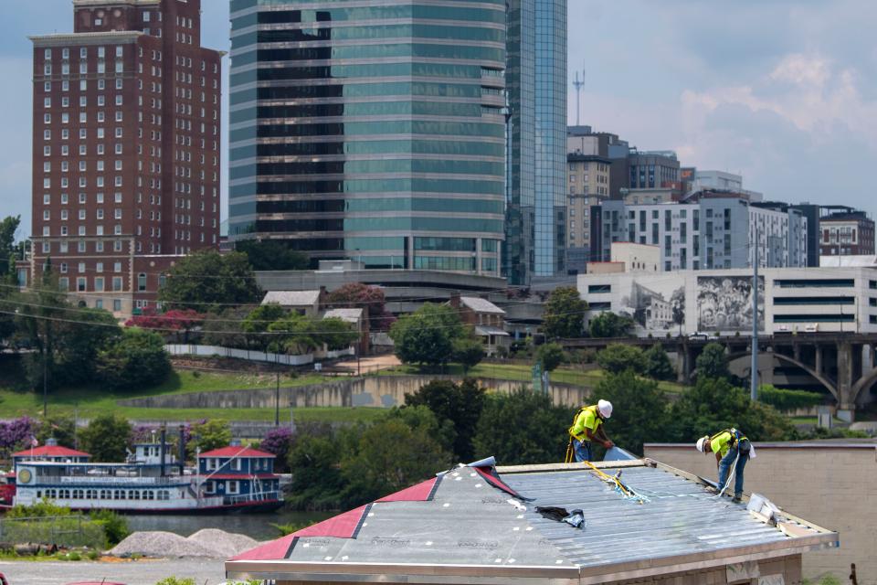 Contractors install a roof at the construction site for a new KUB new pump station along the South Knoxville riverfront July 25, 2023. Construction is 80% complete, but electrical work, hydraulic systems testing and landscaping still needs to be done.