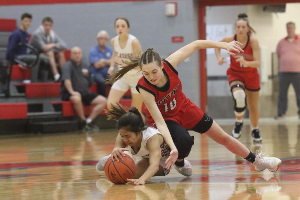 Willard's Syana Sivongsak and Bucyrus' Brook Dennison dive for a loose ball during the Flashes win over Lady Red on Wednesday night in the Division III sectional semifinals.