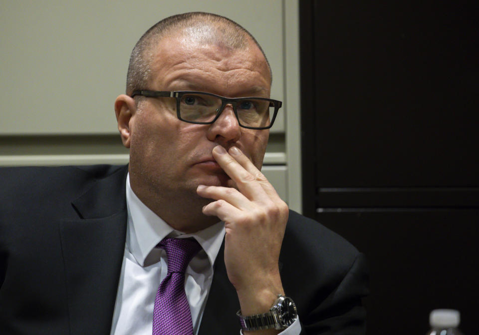 In this Wednesday, Nov. 28, 2018 photo, former Chicago Police Detective David March watches dash-cam video projected by prosecution team during the trial of Chicago police Officer Thomas Gaffney, March and ex-Officer Joseph Walsh during a bench trial before Judge Domenica A. Stephenson at Leighton Criminal Court Building in Chicago. The three Chicago police officers who are charged with lying to protect Jason Van Dyke, a fellow officer from criminal prosecution after he fatally shot black teenager Laquan McDonald in 2014 began Tuesday. (Zbigniew Bzdak/Chicago Tribune via AP, Pool)