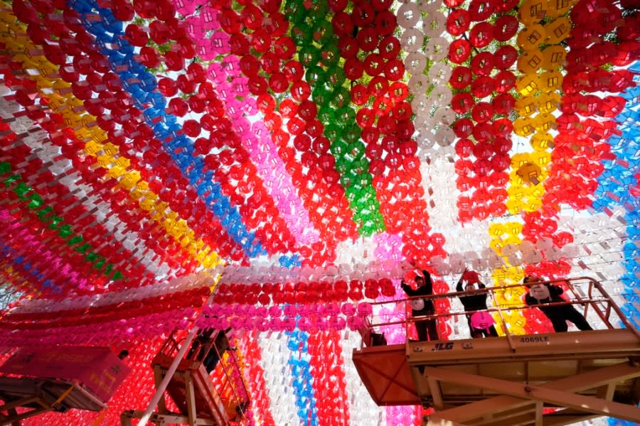 Workers hang lanterns for an annual festival celebrating the birthday of Buddha, at Jogye temple in Seoul, South Korea, Friday, May 10, 2024. (AP Photo/Ahn Young-joon)