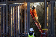 FILE - Crews construct a section of border wall in San Bernardino National Wildlife Refuge, Tuesday, Dec. 8, 2020, in Douglas, Ariz. President Biden on Wednesday ordered a "pause" on all wall construction within a week, one of 17 executive edicts issued on his first day in office, including six dealing with immigration. The order leaves projects across the border unfinished and under contract after Trump worked feverishly last year to reach 450 miles, a goal he announced was achieved eight days before leaving office. (AP Photo/Matt York)