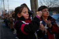 Ashlin (L) and Jude Burkhart, from Murrysville, hold candles during a prayer vigil for victims of the Franklin Regional High School stabbing rampage, at Calvary Lutheran Church in Murrysville, Pennsylvania April 9, 2014. REUTERS/Shannon Stapleton