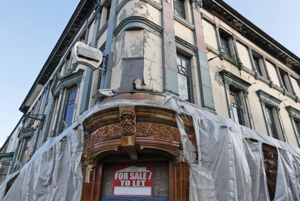 A dilapidated former public house boarded up on the high street in Hartlepool, England, Monday, Nov. 11, 2019. Political parties in Britain's Brexit-dominated December election are battling fiercely to win Hartlepool and places like it: working-class former industrial towns with voters who could hold the key to the prime minister's office at 10 Downing Street. Hartlepool, a former shipbuilding center 250 miles (400 kms) north of London where unemployment is more than double the national average, is a town full of leavers. (AP Photo/Frank Augstein)