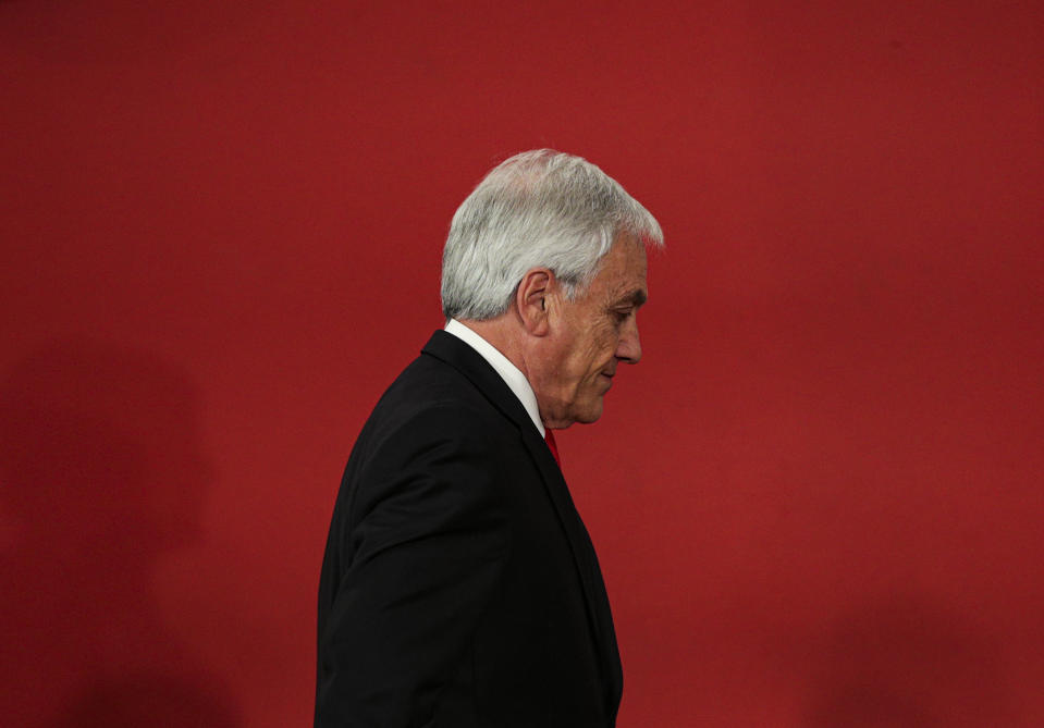 FILE - Chilean President Sebastian Pinera leaves at the end of a ceremony where he introduced his reshuffled Cabinet at La Moneda presidential palace in Santiago, Chile, Oct. 28, 2019. Piñera died on Tuesday, Feb. 6, 2024 in a helicopter crash in Lago Ranco, Chile, according to Chilean Interior Minister Carolina Tohá who announced it on live TV. (AP Photo/Esteban Felix, File)