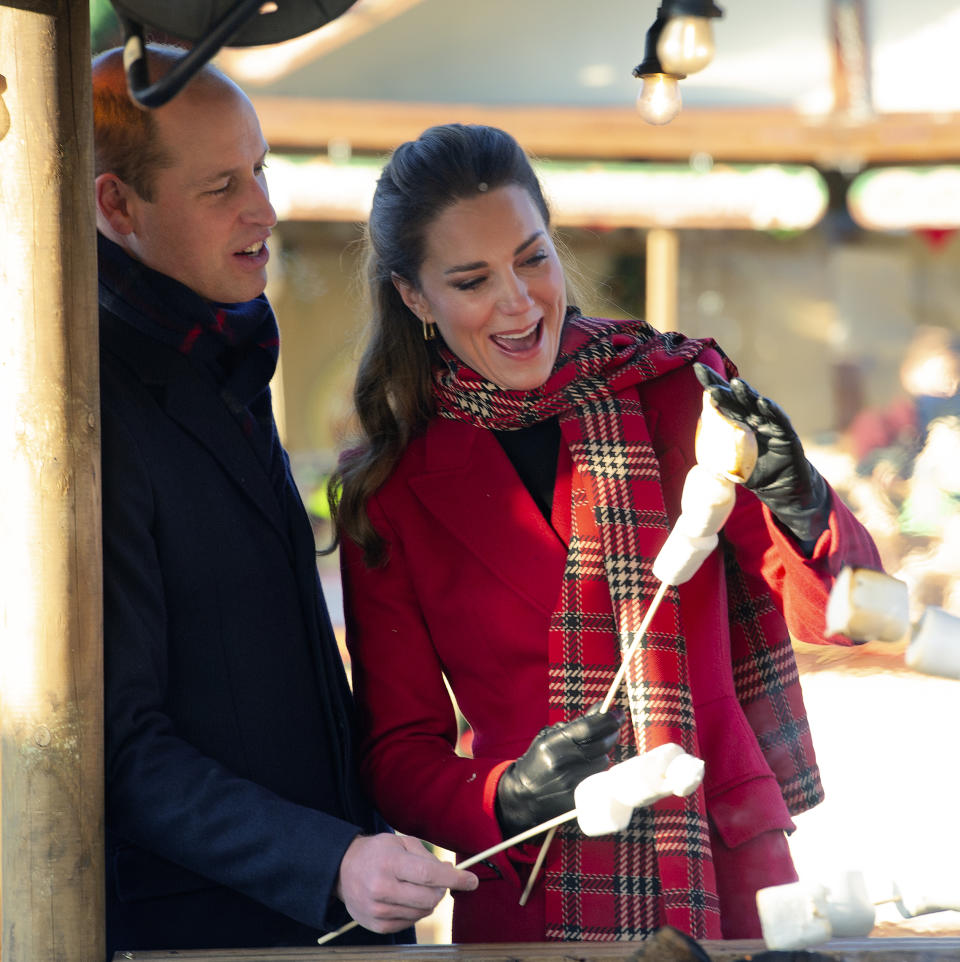 CARDIFF, WALES - DECEMBER 08: Prince William, Duke of Cambridge and Catherine, Duchess of Cambridge toast marshmallows during a visit to Cardiff Castle to meet local university students and hear about some of the challenges they have experienced during the pandemic, with a particular focus on mental health on December 08, 2020 in Cardiff, Wales. The Duke and Duchess are undertaking a short tour of the UK ahead of the Christmas holidays to pay tribute to the inspiring work of individuals, organizations and initiatives across the country that have gone above and beyond to support their local communities this year. (Photo by Jonathan Buckmaster - Pool / Getty Images)