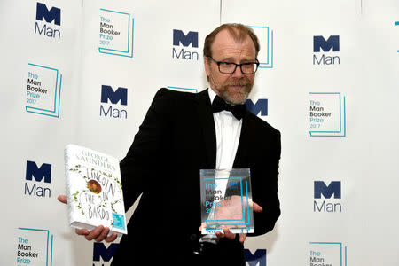 George Saunders, author of 'Lincoln in the Bardo', poses for photographers after winning the Man Booker Prize for Fiction 2017 in London, Britain, October 17, 2017. REUTERS/Mary Turner