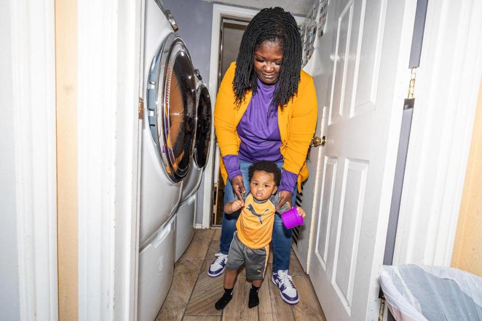 Child care center director Roslyn Chaney guides her infant student Kingston Wooten to the infant sleeping area in the evening at the Future Scholars’ Childcare and Transportation child care home in Grand Prairie on Thursday, March 14, 2024. Future Scholars’ is one of few programs in Tarrant County that provide 24/7 child care. Chris Torres/ctorres@star-telegram.com