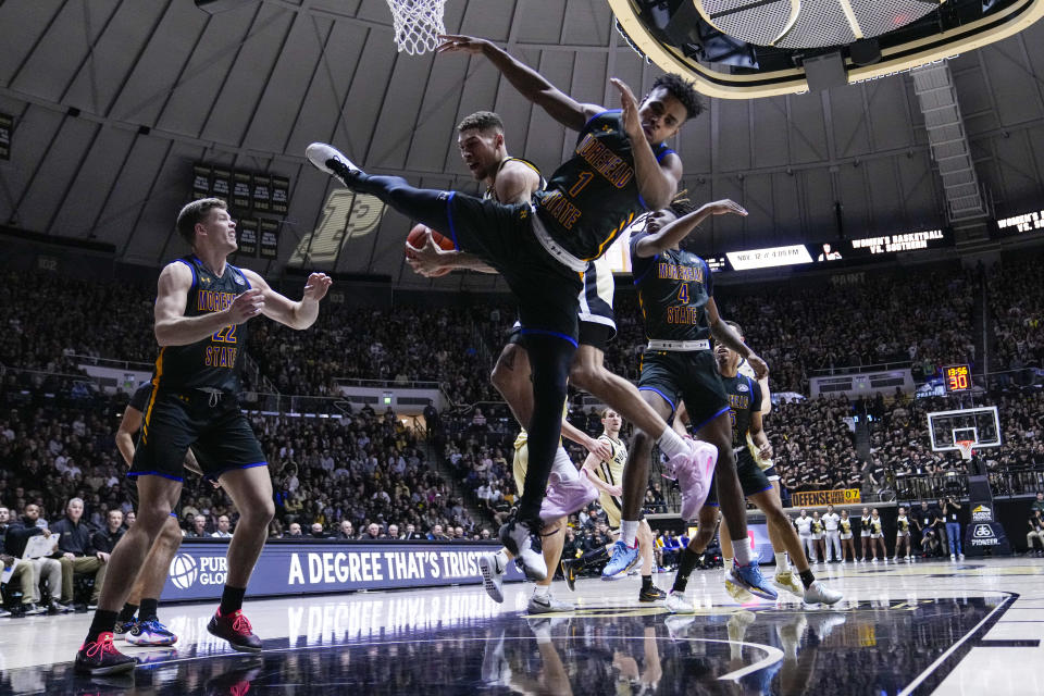 Purdue forward Mason Gillis (0) grabs a rebound behind Morehead State guard Jerone Morton (1) during the second half of an NCAA college basketball game in West Lafayette, Ind., Friday, Nov. 10, 2023. (AP Photo/Michael Conroy)