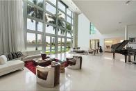 <p>The living room has two-storey floor-to-ceiling windows. (Realtor.com) </p>