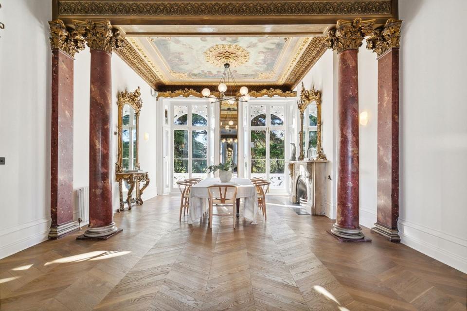 Stone columns and a frescoed ceiling adorn the dining room (Savills)