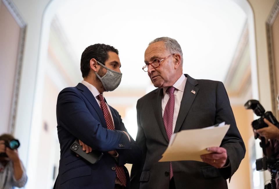 Senate Majority Leader Chuck Schumer, D-N.Y., talks to an aide following a Democratic policy luncheon at the U.S. Capitol on Sept. 28, 2021 in Washington, D.C.