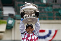 Jockey Manny Franco holds up the August Belmont trophy after riding Tiz the Law to win the 152nd running of the Belmont Stakes horse race, Saturday, June 20, 2020, in Elmont, N.Y. (AP Photo/Seth Wenig)