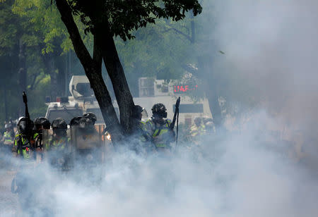 Riot police take position while clashing with opposition supporters during a rally against President Nicolas Maduro in Caracas, Venezuela, May 4, 2017 REUTERS/Carlos Garcia Rawlins