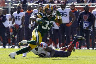Green Bay Packers running back Aaron Jones heads to the end zone past Chicago Bears safety Tashaun Gipson on a touchdown reception from quarterback Aaron Rodgers during the second half of an NFL football game Sunday, Oct. 17, 2021, in Chicago. (AP Photo/David Banks)