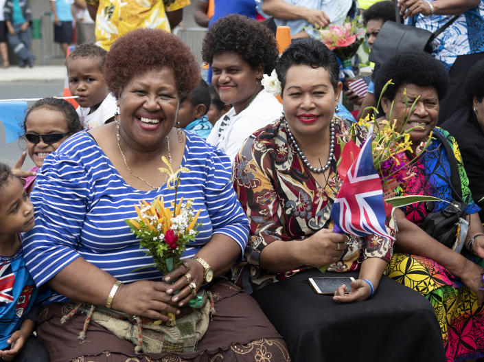 Local Fijian women wait for the arrival of Meghan, Duchess of Sussex at a market in Suva, Fiji, Wednesday, Oct. 24, 2018. Prince Harry and his wife Meghan are on day nine of their 16-day tour of Australia and the South Pacific. (Ian Vogler/Pool Photo via AP)