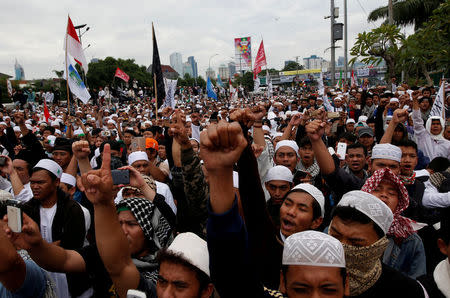 FILE PHOTO: Indonesian Islamist groups attend a rally outside the parliament calling for the government to suspend the Christian governor of the captial, Basuki Tjahaja Purnama, and for the courts to convict him of blasphemy, in Jakarta, Indonesia February 21, 2017. REUTERS/Darren Whiteside/File Photo