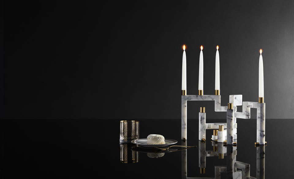 This image provided by Novita Italia shows a Vestalia white marble candlestick holder. Virginia Valentini and Francesco Breganze of the Italian studio LatoxLato have designed a clever candelabrum; they use a water jet to precisely cut small slabs of marble. Closed, the pieces look like a solid slab. But with a few light pushes, a series of candleholders accordions outward, creating an elegant objet d'art. (Novita Italia via AP)