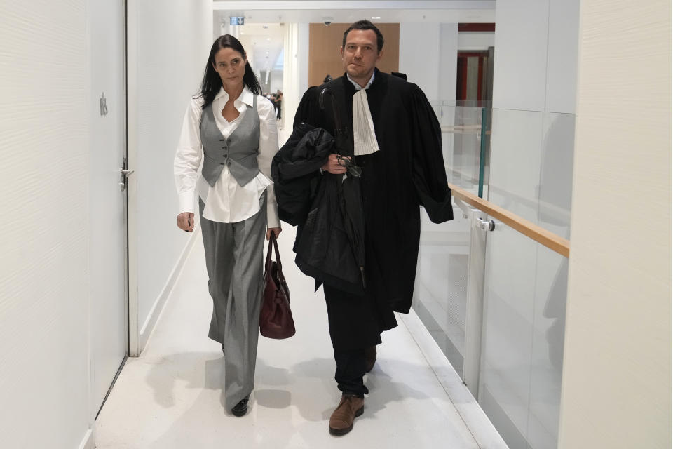 British actor Charlotte Lewis arrives with her lawyer Benjamin Chouai before the verdict against filmmaker Roman Polanski Tuesday, May 14, 2024 in Paris. Roman Polanski was acquitted of defaming the actor whom he described as a liar after she accused the director of sexual assault. (AP Photo/Thibault Camus)