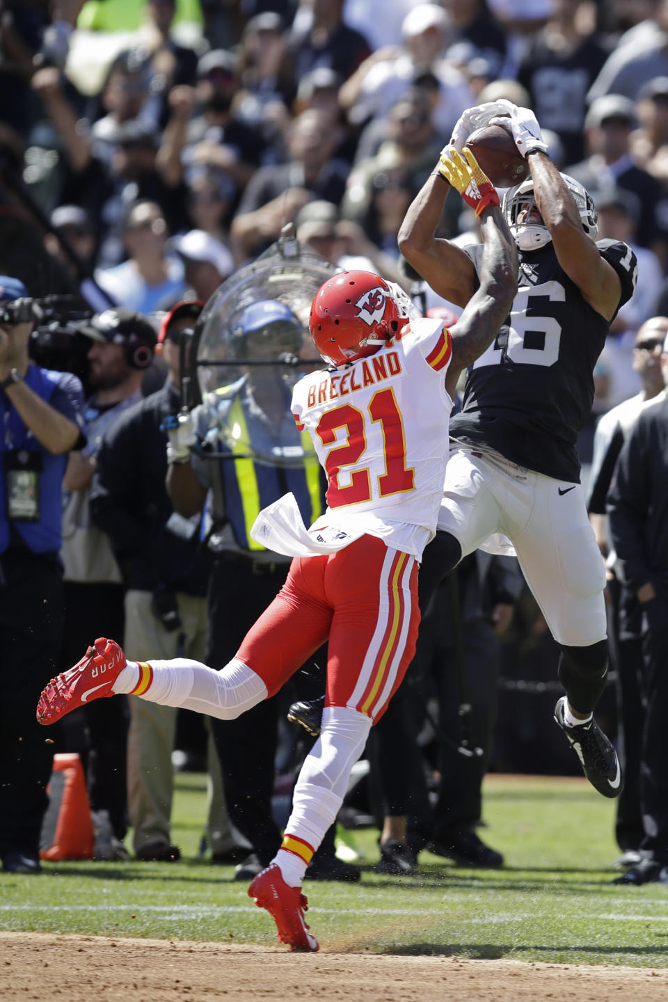Oakland Raiders wide receiver Tyrell Williams (16) catches a pass as Kansas City Chiefs defensive back Bashaud Breeland (21) looks on during the first half of an NFL football game Sunday, Sept. 15, 2019, in Oakland, Calif. (AP Photo/Ben Margot)