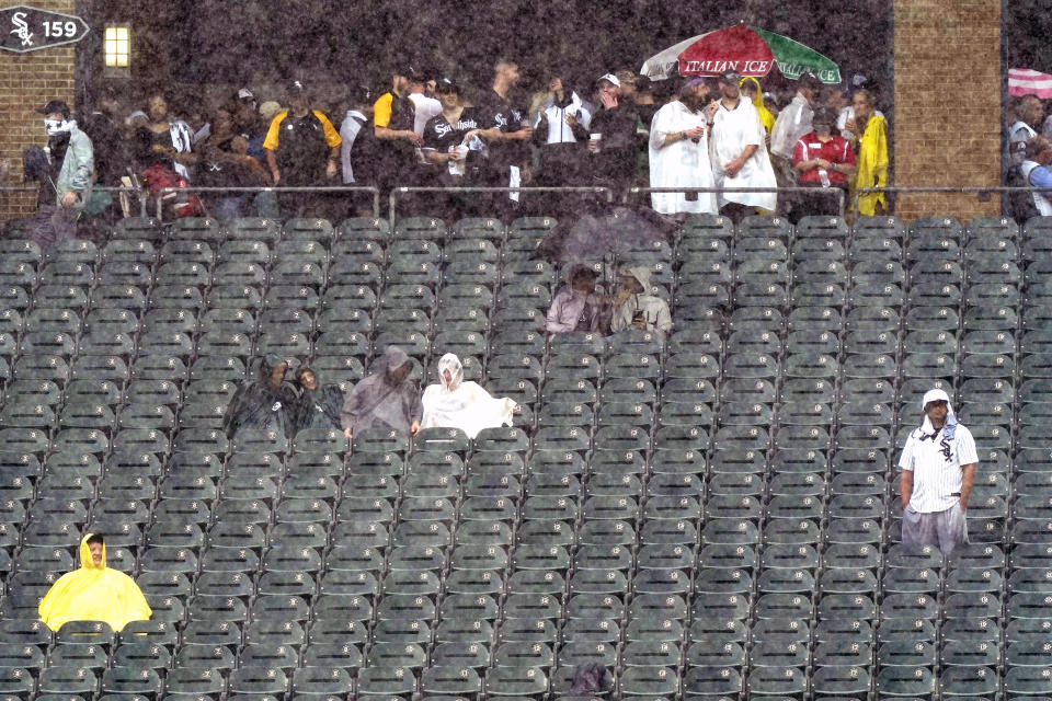 Fans look to the field as they wait during a rain delay in the third inning of a baseball game between the Seattle Mariners and the Chicago White Sox in Chicago, Saturday, June 26, 2021. (AP Photo/Nam Y. Huh)