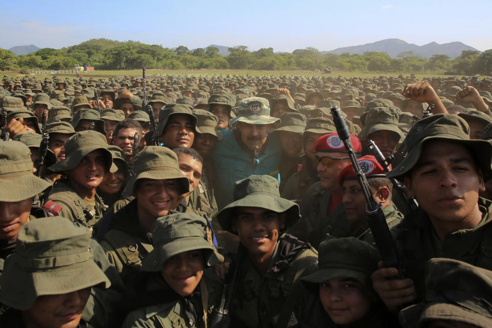 In this handout photo released by Miraflores Press Office, Venezuela's President Nicolas Maduro poses for a group photo with cadets at the G/J José Laurencio Silva training center in the state of Cojedes, Venezuela, Saturday, May 4, 2019. (Jhonn Zerpa/Miraflores Press Office via AP)