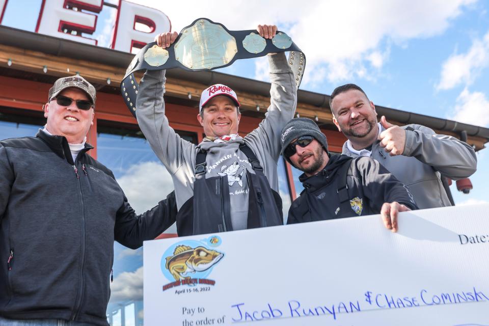 Jacob Runyan holding up a champion's belt alongside Chase Cominsky at the Rossford Walleye Roundup Tournament in Rossford, Ohio, on April 16, 2022.