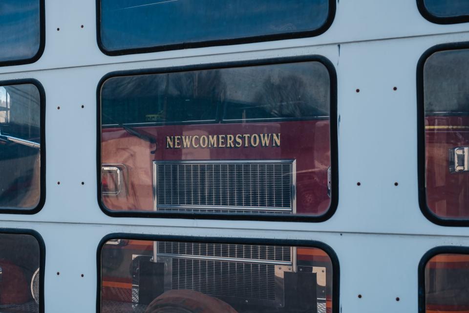 A Newcomerstown Fire Department truck can be seen through the windows of the firehouse bay door. The apparatus was formerly owned and run by Newcomerstown Emergency Rescue Squad Inc.