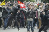 Rioters throw projectiles during a protest against the government's labour market reforms in Paris, on May 26, 2016