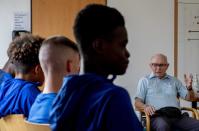 CORRECTS SPELLING OF NAME TO SHAUL PAUL LADANY INSTEAD OF SHAUL PAUL LADY - Holocaust survivor Shaul Paul Ladany talks to youth players of FC Chelsea in Nuremberg, Germany, Friday, July 29, 2022. Some of Europe's best young soccer players from the under-17 teams of Chelsea, Bayern Munich, Bologna and other international clubs contest the Walther Bensemann Memorial Tournament in Nuremberg, where they also learn the dangers of intolerance by meeting Holocaust survivors, attending workshops and taking part in excursions. (AP Photo/Michael Probst)